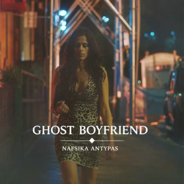 Woman in a leopard print dress walking on a city street at night, with Ghost Boyfriend text.